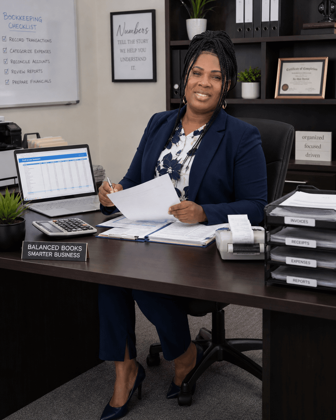 Professional woman smiling at her office desk with accounting tools, a laptop, and organized documents.